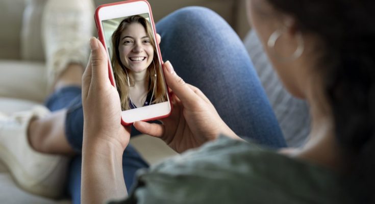 A person hold a phone talking in video calling